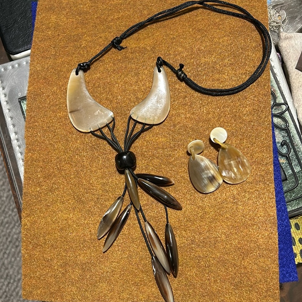 beautiful bone or resin. not quite the sure necklace and earrings